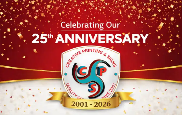 Creative Printing and signs 25th Anniversary logo with the blue background and a white shield in the middle with the years 2001-2026 in a gold banner at the bottom