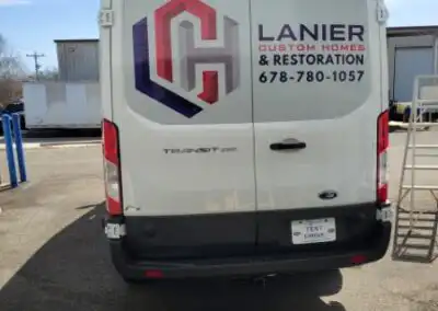 Back Window Decals for Lanier Custom Homes & Restoration work van with the logo on the drivers side and the name and phone number on the passenger side