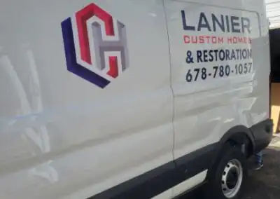 Decals for Lanier Custom Homes & Restoration work van left side from a different angle