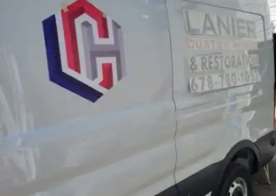 Decals for Lanier Custom Homes & Restoration work van left side from a closer angle