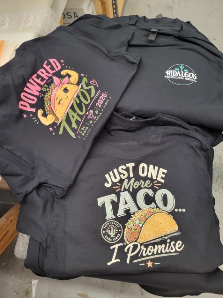 Creative Printing and Signs TShirt Hidalgo's Dark grey T-Shirts for Hildalgo's Mexican Grill celebrating Cinco De Mayo with the name on the front pocket and a taco and slogan on the back