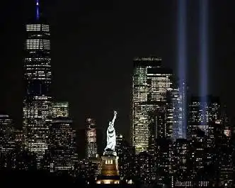 New York City and the Statue of Liberty photo that also shows the lights where the Twin Towers used the stand at the World Trade Center Complex remembering September 11, 2001